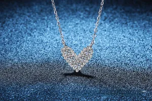 Detail of V-shaped heart pendant necklace in S925 silver with sparkling zircon pavé