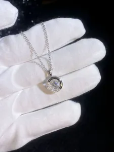 Macro shot of S925 sterling silver donut pendant with a dancing moissanite center stone
