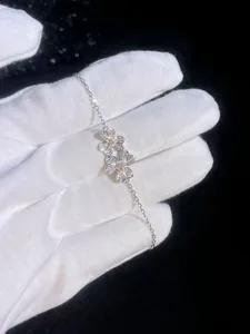 Macro close-up of S925 sterling silver clover bracelet with sparkling moissanite stones