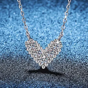 S925 sterling silver V-shaped heart necklace with round moissanite on blue glitter background