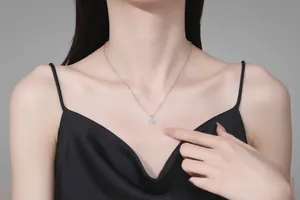 Close-up of S925 sterling silver four-leaf clover necklace with moissanite on model