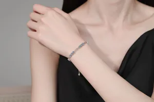 Close-up of S925 silver bracelet featuring blue moissanite stones on a woman's wrist