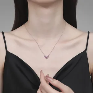 Pink heart-shaped moissanite necklace in 925 sterling silver worn by a model