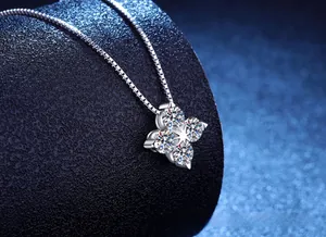 Close-up of D color moissanite four-leaf clover pendant on S925 silver box chain