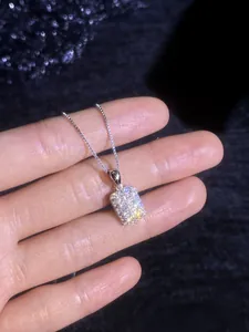 Macro shot of S925 sterling silver square pendant with shimmering pavé moissanite stones