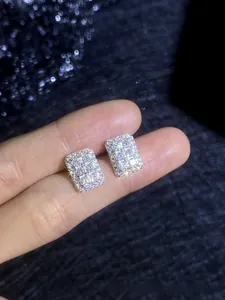 Close-up of S925 sterling silver square moissanite stud earrings on a finger