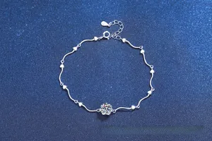 Macro shot of S925 sterling silver bracelet with heart charms and moissanite stone