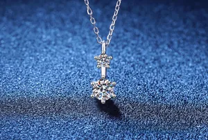 Macro shot of S925 sterling silver necklace with classic double round moissanite pendants