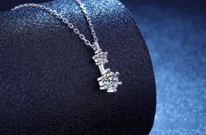 Macro shot of S925 sterling silver double-stone moissanite pendant with classic round cut
