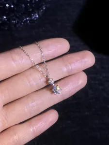 Detailed macro view of S925 sterling silver necklace featuring two moissanite stones