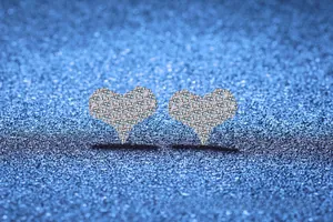 Macro shot of S925 sterling silver heart stud earrings with moissanite pavé setting