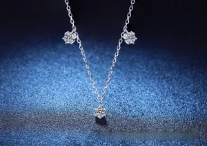 Macro shot of S925 sterling silver necklace featuring three six-prong moissanite pendants
