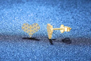 Detailed macro view of heart-shaped gold studs featuring pavé-set moissanite stones