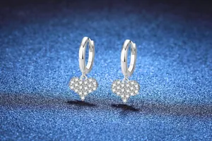 Close-up of 925 sterling silver heart earrings featuring sparkling moissanite pavé stones