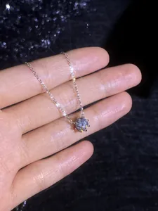 Detailed view of 1 carat moissanite solitaire necklace with six-prong silver setting