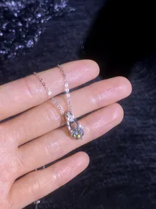 Detail of S925 sterling silver moissanite necklace featuring a double-stone pendant design