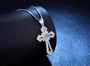 Detailed macro shot of an S925 sterling silver cross pendant with moissanite stones