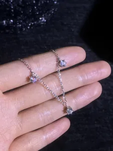 Detailed view of S925 sterling silver necklace with three claw-set moissanite pendants