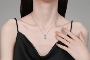 Detail of Moissanite S925 silver necklace with light blue pendant on female model
