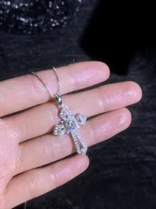Close-up of S925 sterling silver cross pendant necklace with sparkling moissanite stones