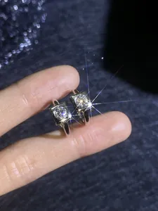 Macro shot of square geometric S925 sterling silver stud earrings with D color moissanite