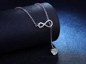 Detail of S925 sterling silver infinity necklace with 1 carat moissanite and tassel pendant