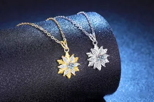 Close-up of gold and silver snowflake pendants with shimmering zircon stones on display