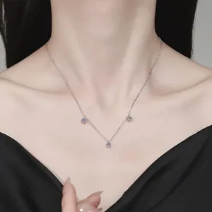 Elegant S925 sterling silver necklace with three sparkling moissanite stones on a model