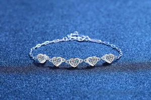 Detailed close-up of S925 sterling silver heart-shaped bracelet with moissanite stones