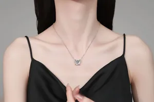 Close-up of S925 silver necklace featuring a dancing heart pendant with sparkling moissanite