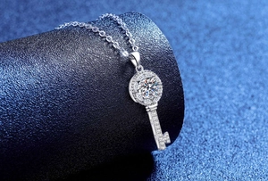 Macro shot of silver S925 key pendant necklace with sparkling moissanite stones
