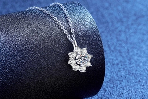 Macro detail of sunflower moissanite pendant with 925 sterling silver chain