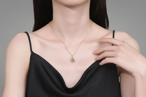 Detail of S925 silver water drop pendant with blue stone worn by a model