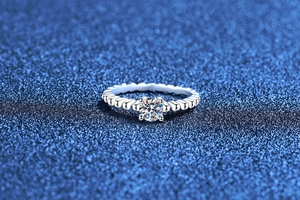 Macro shot of 0.5 carat moissanite set in a beaded S925 sterling silver ring band