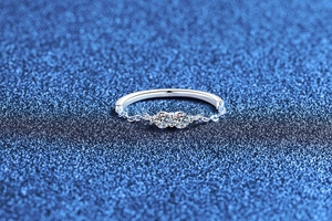 Macro shot of stylish chain-link ring with two brilliant moissanite stones on starry background