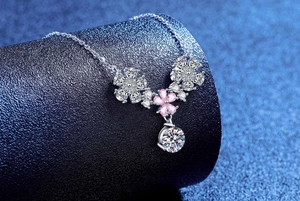 Close-up of sparkling moissanite floral pendant with pink stone in 925 sterling silver