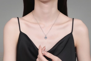 S925 sterling silver snowflake necklace with blue moissanite on a model neck