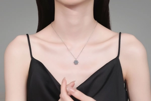Close-up of S925 silver sunflower necklace with blue moissanite pendant on a model