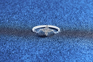 Detailed macro view of S925 sterling silver four-leaf clover ring with brilliant stones