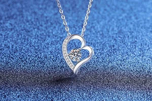 Detailed close-up of S925 sterling silver heart pendant with sparkling moissanite stone