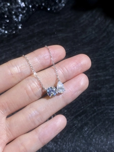 Detail view of pear and round cut moissanite pendant on S925 sterling silver chain