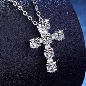 S925 sterling silver cross necklace with pavé moissanite stones on a blue display