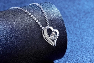 Macro detail of S925 sterling silver heart pendant with moissanite and micro-pave diamonds