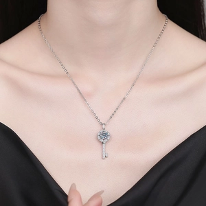 Elegant S925 sterling silver key necklace with moissanite pendant worn by a model