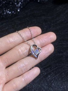 Close-up of S925 silver heart necklace with brilliant moissanite and pave accents