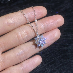 Handheld view of S925 sterling silver moissanite sunflower pendant necklace with shiny stones