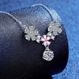 925 silver necklace with flower pendants and sparkling moissanite on blue display