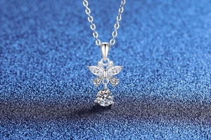 Detailed close-up of butterfly wing pendant with moissanite stones on a delicate silver chain