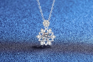 Macro shot of 1 carat moissanite snowflake pendant with starburst details on blue background
