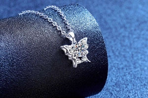 Close-up of butterfly pendant necklace in S925 silver with sparkling moissanite stones